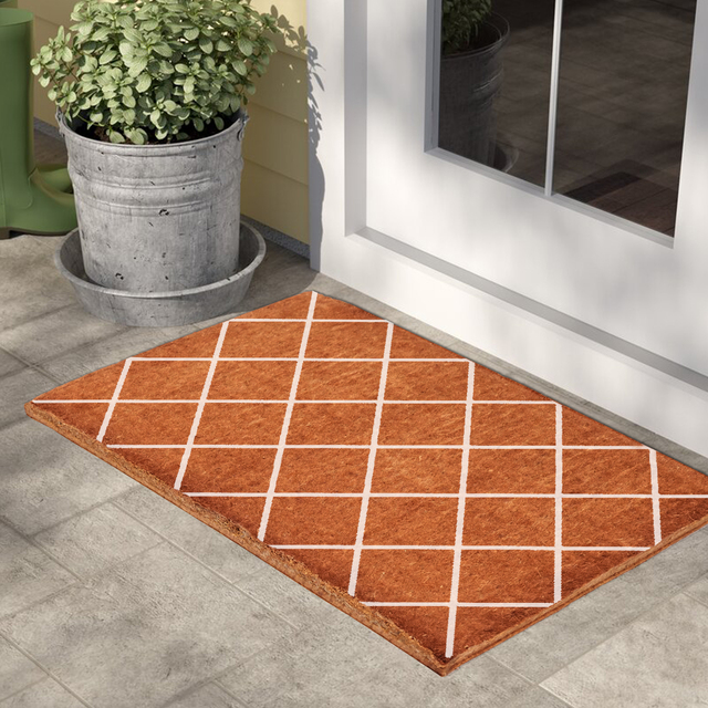 Coir doormat with diamond print in white at white door