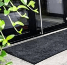 Photo of charcoal door mat at black door