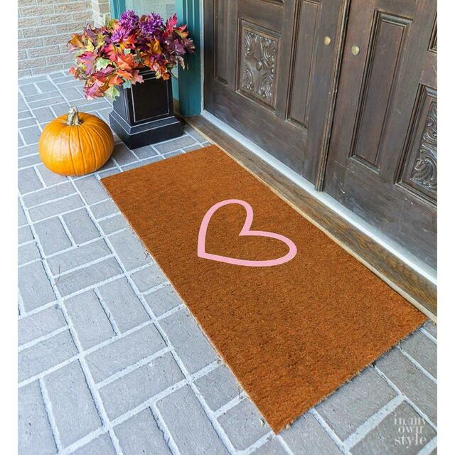 Double coir mat with pink heart at brown double doors