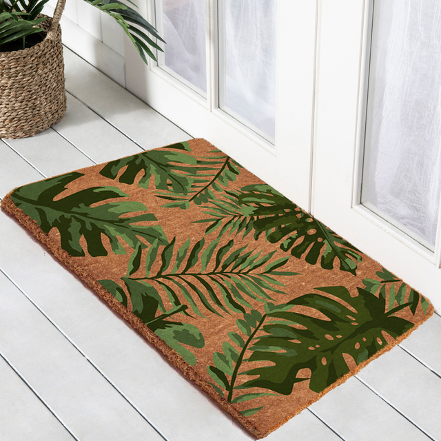 Monstera printed door mat on white timber deck at white door