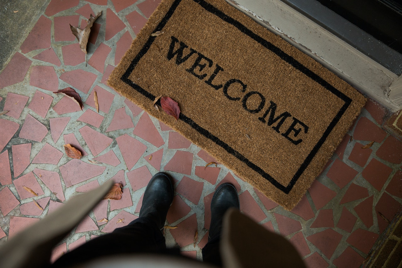 Photo of welcome coir mat at front door on terracotta tiles