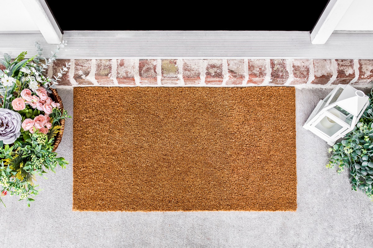 Plain coir mat at front door with brick step