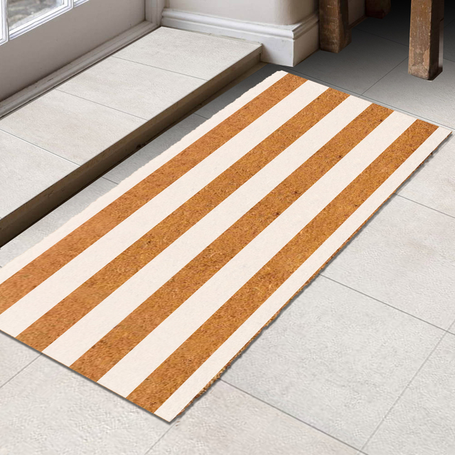 White horizontal striped coir door mat at door